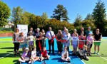 Councillors, Members of WDL and tennis association with children from Whitecrook Primary school cut red ribbon on tennis courts in Whitecrook