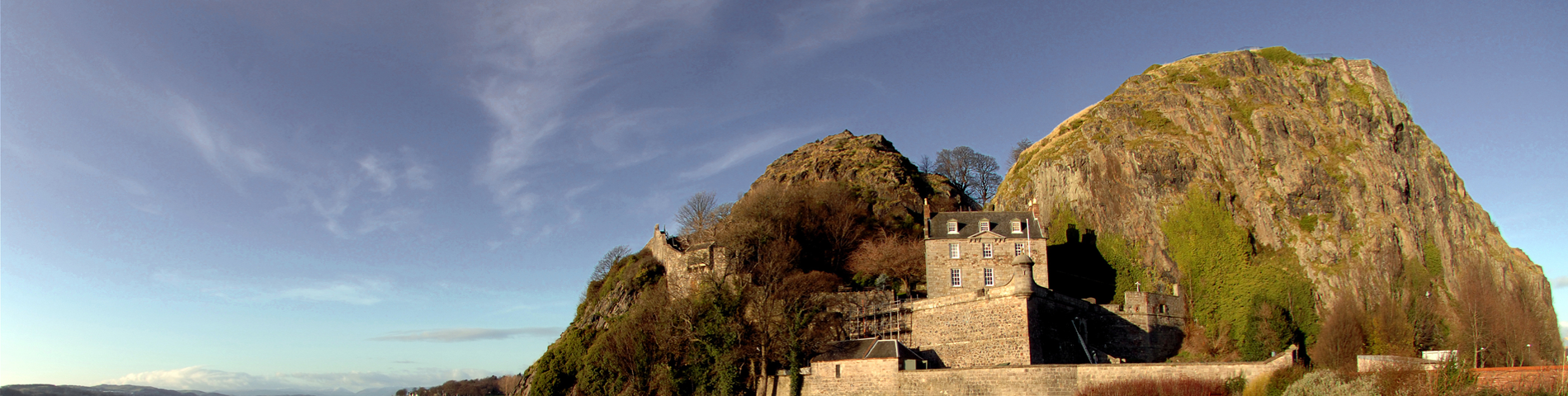 Photo of Dumbarton Castle with  blue sky over head with a few thin clouds