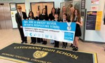 A group of Clydebank High School pupils and staff proudly holding their UNICEF Silver Rights Respecting School Award certificate outside the school building.