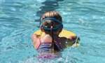 young swimmer learning to swim