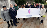 Provost, Deputy Lord Lieutenant, Councillors and guests holding Holocaust Memorial Day flag