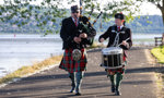 Piper Tam Gray and Drummer Alexander Brown walk along a path at Levengrove Park 