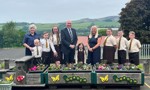 Councillors, Header Teacher and pupils from St Ronan’s Primary school standing in the playground