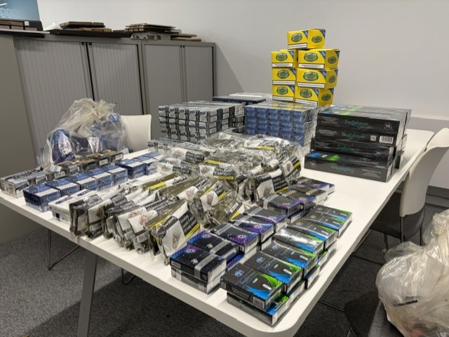 A pile of various counterfeit cigarette and tobacco packets seized by Trading Standards officers