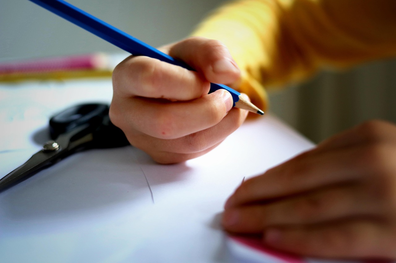 Young person with a pencil, doing some crafting