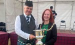 Provost Karen Murray Conaghan presents winners trophy to Inveraray and District Pipe Band