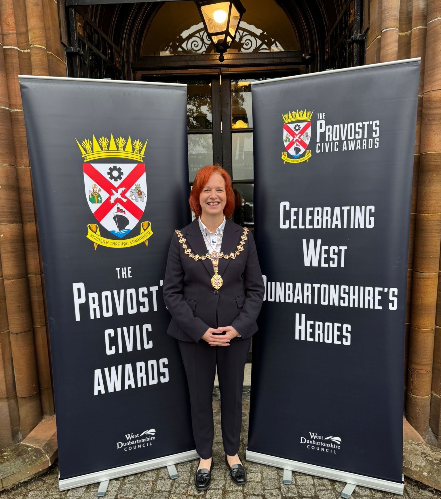 Provost Karen Murray Conaghan - beside signs for the Provost's Civic Awards